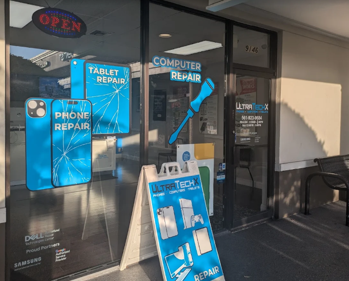 The UltraTechX storefront at 9146 Glades Rd in Boca Raton, with a walk-in counter and posted phone number